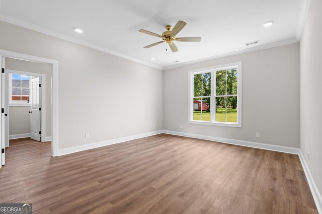 9 Honeysuckle Dr, Claxton, GA 30417 - unfurnished room with healthy amount of natural light, wood finished floors, ceiling fan, crown molding, and recessed lighting