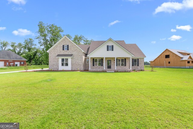 9 Honeysuckle Dr, Claxton, GA 30417 - view of front facade featuring brick siding, a front lawn, and covered porch