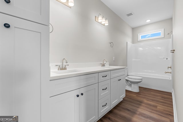 9 Honeysuckle Dr, Claxton, GA 30417 - bathroom with double vanity,  shower combination, and wood finished floors