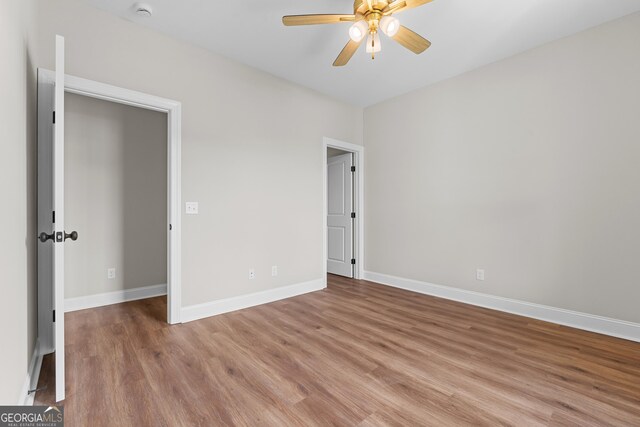9 Honeysuckle Dr, Claxton, GA 30417 - unfurnished bedroom with wood finished floors and ceiling fan