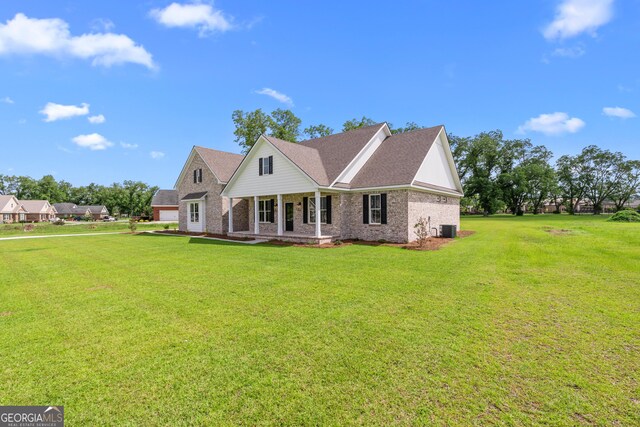 9 Honeysuckle Dr, Claxton, GA 30417 - back of house featuring covered porch, brick siding, a lawn, and roof with shingles