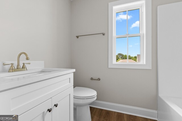 9 Honeysuckle Dr, Claxton, GA 30417 - full bath with wood finished floors, vanity, and a tub