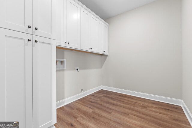 9 Honeysuckle Dr, Claxton, GA 30417 - laundry area featuring electric dryer hookup, cabinet space, washer hookup, and wood finished floors