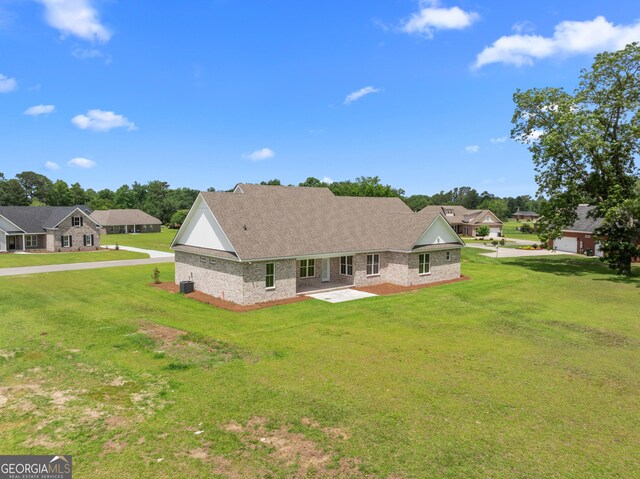 9 Honeysuckle Dr, Claxton, GA 30417 - rear view of house with a yard, a patio area, and roof with shingles