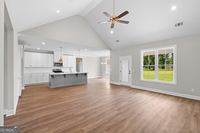 9 Honeysuckle Dr, Claxton, GA 30417 - unfurnished living room featuring high vaulted ceiling, ceiling fan, recessed lighting, plenty of natural light, and light wood-type flooring