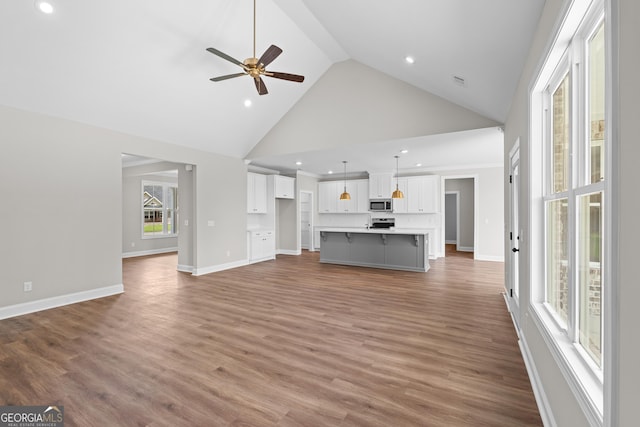 9 Honeysuckle Dr, Claxton, GA 30417 - unfurnished living room with high vaulted ceiling, ceiling fan, wood finished floors, and recessed lighting