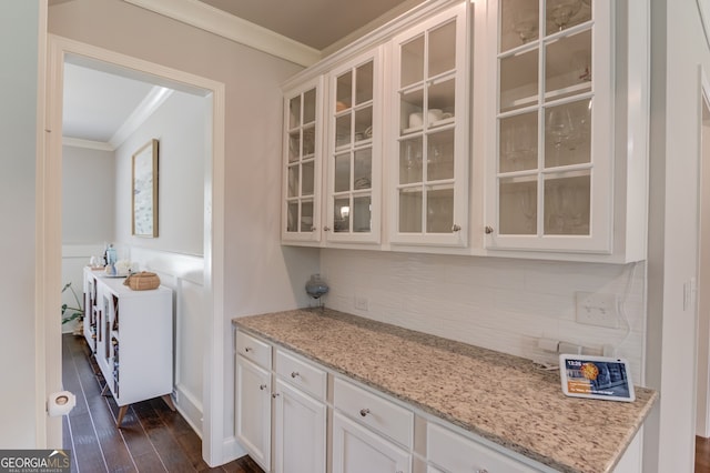 396 Brant Cir, Jefferson, GA 30549 - bar area featuring crown molding, decorative backsplash, dark wood-type flooring, and wainscoting