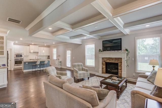 396 Brant Cir, Jefferson, GA 30549 - living room with beam ceiling, dark wood-style floors, healthy amount of natural light, a fireplace, and recessed lighting