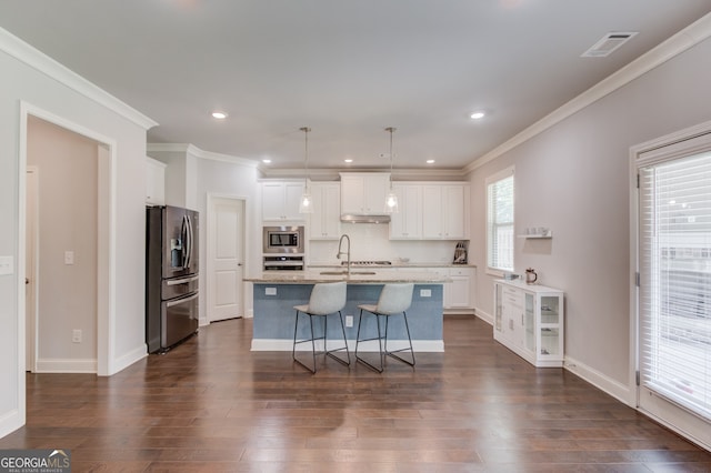 396 Brant Cir, Jefferson, GA 30549 - kitchen with stainless steel appliances, ornamental molding, dark wood-type flooring, white cabinetry, and a breakfast bar