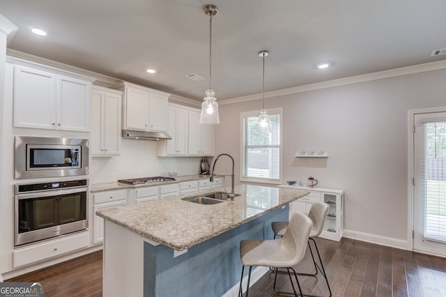 396 Brant Cir, Jefferson, GA 30549 - kitchen featuring stainless steel appliances, dark wood finished floors, ornamental molding, under cabinet range hood, and white cabinetry