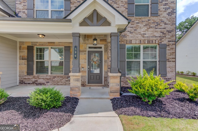 396 Brant Cir, Jefferson, GA 30549 - property entrance featuring covered porch, brick siding, and stone siding