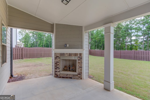 396 Brant Cir, Jefferson, GA 30549 - fenced backyard featuring an outdoor brick fireplace and a patio area