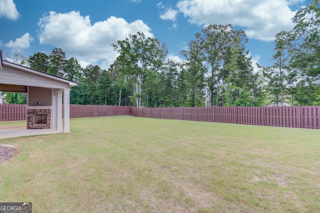 396 Brant Cir, Jefferson, GA 30549 - fenced backyard featuring an outdoor brick fireplace