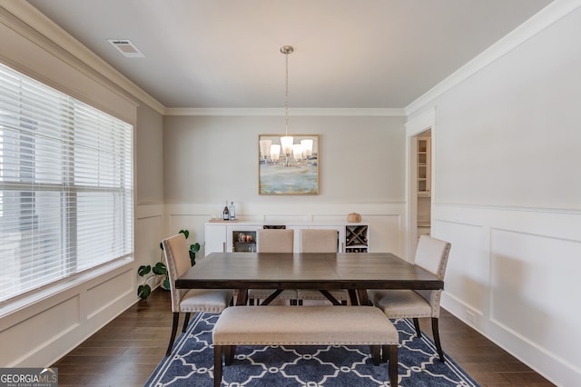396 Brant Cir, Jefferson, GA 30549 - dining space with a chandelier, a decorative wall, wainscoting, crown molding, and dark wood finished floors