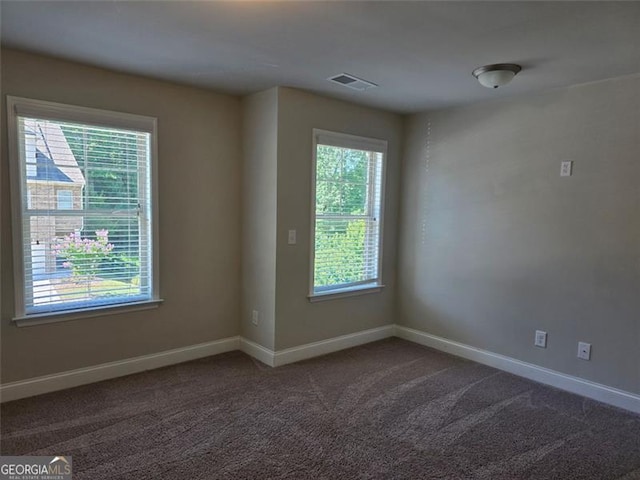 5715 Rocky Falls Dr, Suwanee, GA 30024 - spare room with baseboards and dark colored carpet