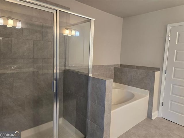 5715 Rocky Falls Dr, Suwanee, GA 30024 - bathroom featuring a bath, a stall shower, and tile patterned flooring
