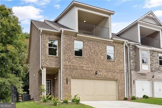 5715 Rocky Falls Dr, Suwanee, GA 30024 - multi unit property featuring a garage, driveway, a balcony, and brick siding