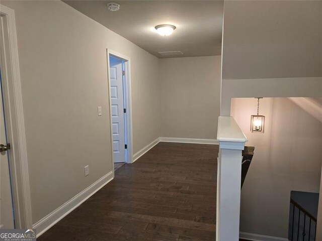 5715 Rocky Falls Dr, Suwanee, GA 30024 - corridor featuring dark wood-style floors and an upstairs landing