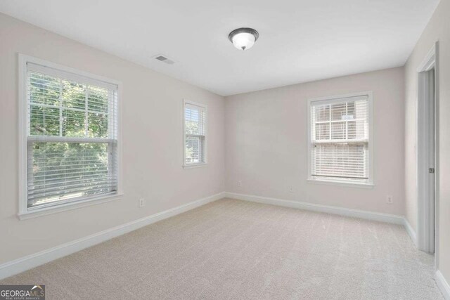 812 Autry Oak Ct, Alpharetta, GA 30022 - unfurnished bedroom with multiple windows and light colored carpet