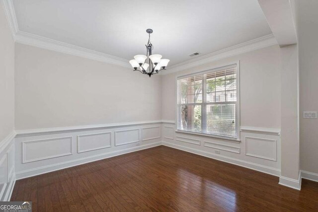 812 Autry Oak Ct, Alpharetta, GA 30022 - empty room featuring a chandelier, ornamental molding, dark wood-style floors, a wainscoted wall, and a decorative wall
