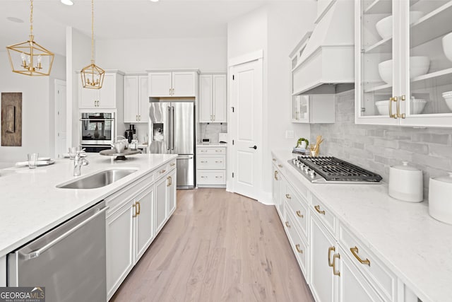 608 Southland Pass, Canton, GA 30115 - kitchen featuring appliances with stainless steel finishes, custom range hood, white cabinetry, decorative light fixtures, and tasteful backsplash