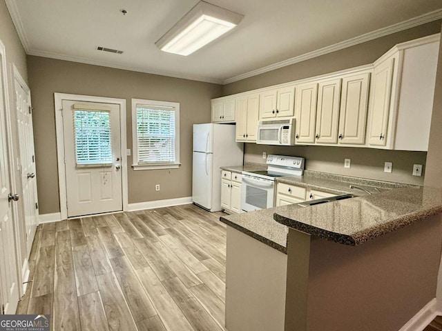 460 Barnett Shoals Rd Unit 5A, Athens, GA 30605 - kitchen featuring white appliances, crown molding, light wood finished floors, a peninsula, and a breakfast bar area
