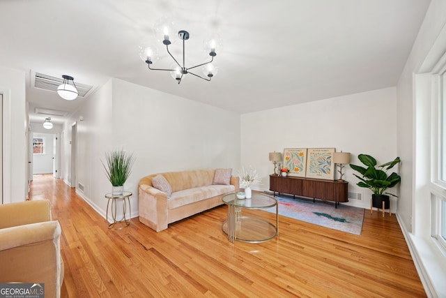 3222 Edgemont Way, Decatur, GA 30032 - living room with light wood-style floors and a chandelier
