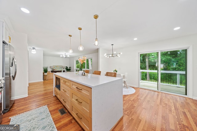 3222 Edgemont Way, Decatur, GA 30032 - kitchen with a chandelier, light countertops, freestanding refrigerator, light wood-style floors, and hanging light fixtures