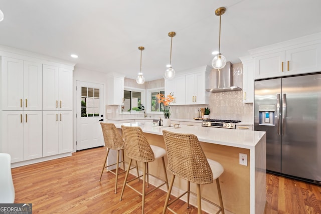 3222 Edgemont Way, Decatur, GA 30032 - kitchen with stainless steel fridge with ice dispenser, wall chimney exhaust hood, light wood finished floors, light countertops, and recessed lighting