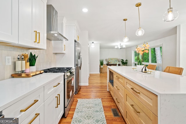 3222 Edgemont Way, Decatur, GA 30032 - kitchen with stainless steel appliances, wall chimney range hood, decorative backsplash, light wood finished floors, and pendant lighting