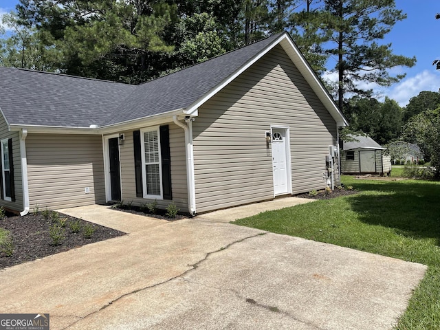 105 Ridgefield Dr, Lagrange, GA 30241 - view of home's exterior with roof with shingles, a yard, and a shed