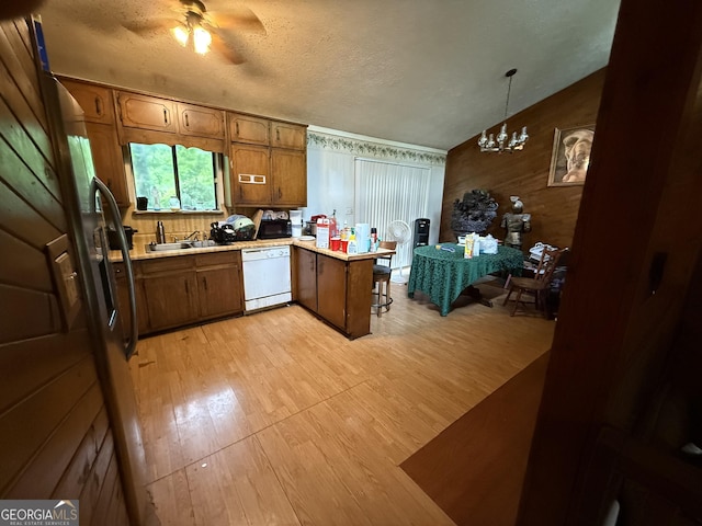 6884 Red Maple Ct, Rex, GA 30273 - kitchen with a peninsula, dishwasher, light wood finished floors, light countertops, and a ceiling fan