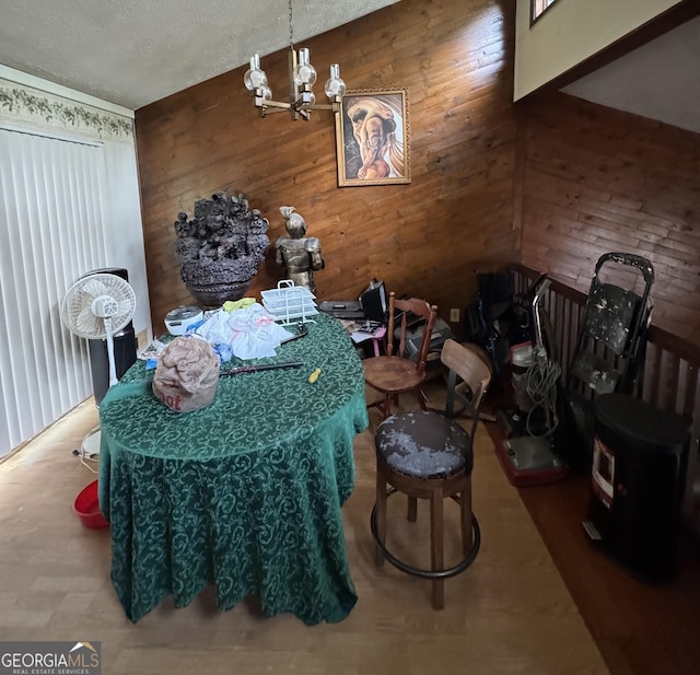 6884 Red Maple Ct, Rex, GA 30273 - dining area featuring wooden walls, a chandelier, and a textured ceiling