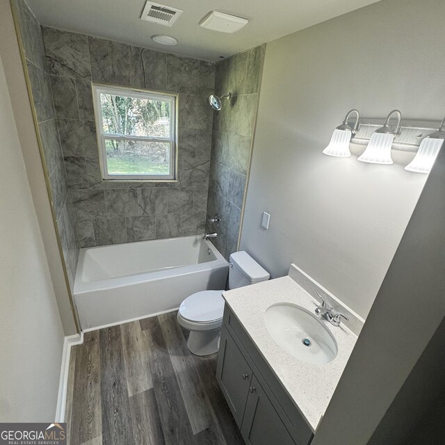 1425 Walls Ln, Macon, GA 31211 - bathroom featuring wood finished floors, shower / washtub combination, and vanity