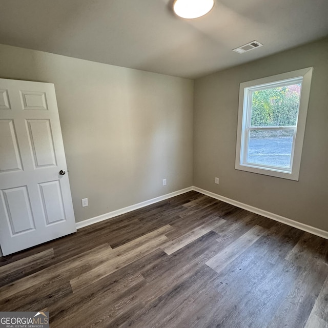 1425 Walls Ln, Macon, GA 31211 - spare room with baseboards and dark wood-style flooring