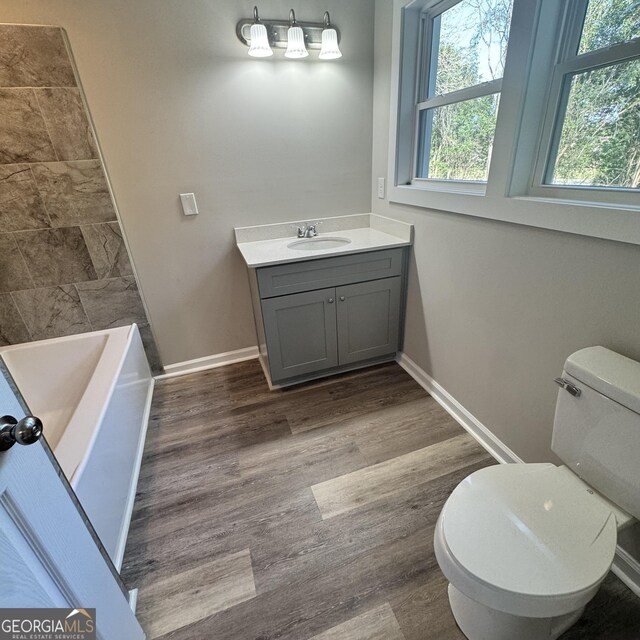 1425 Walls Ln, Macon, GA 31211 - bathroom featuring vanity, a bathtub, wood finished floors, and a shower