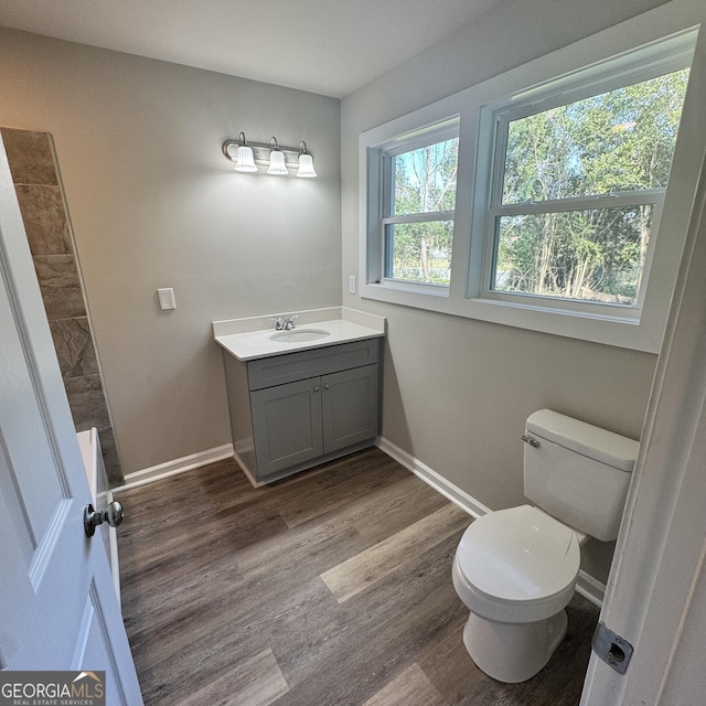 1425 Walls Ln, Macon, GA 31211 - full bathroom with vanity, wood finished floors, and tiled shower