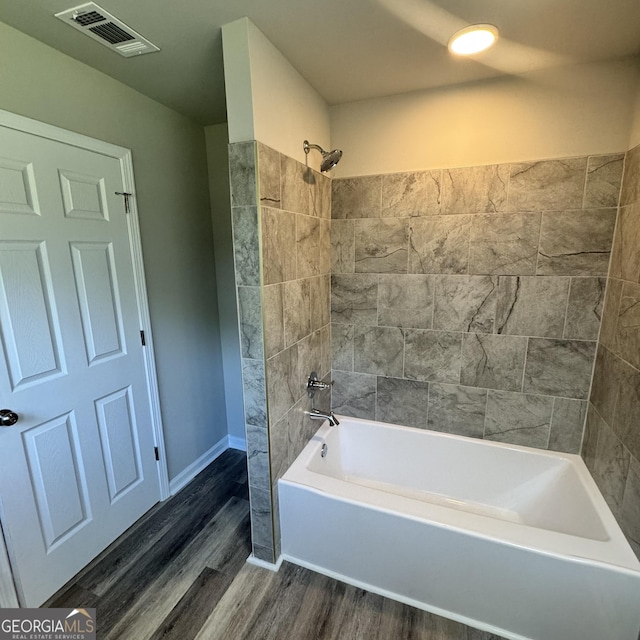 1425 Walls Ln, Macon, GA 31211 - bathroom featuring wood finished floors and tub / shower combination