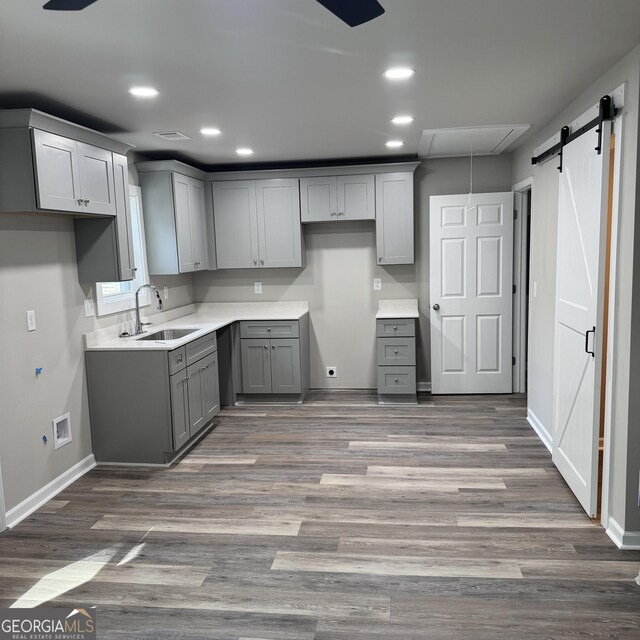 1425 Walls Ln, Macon, GA 31211 - kitchen featuring gray cabinetry, a barn door, recessed lighting, and wood finished floors