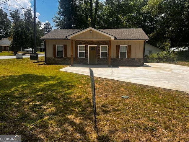 110 Williamson St SW, Rome, GA 30165 - rear view of house featuring a yard, board and batten siding, stone siding, and roof with shingles