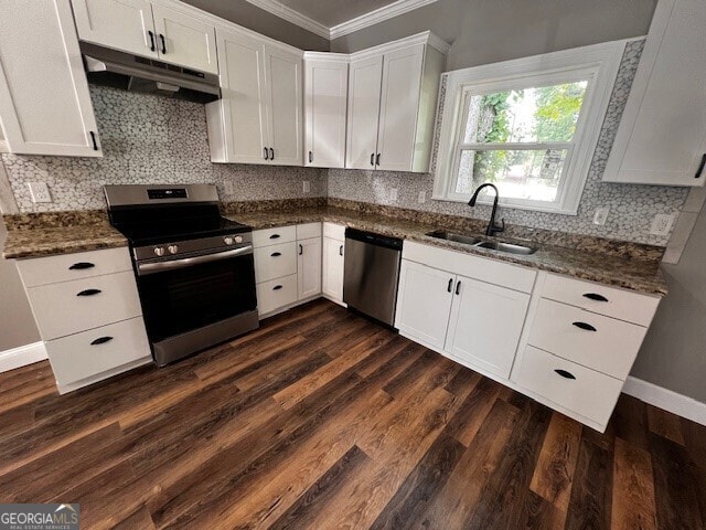 110 Williamson St SW, Rome, GA 30165 - kitchen featuring stainless steel appliances, under cabinet range hood, ornamental molding, white cabinets, and dark wood-style flooring