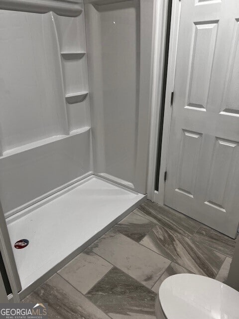 110 Williamson St SW, Rome, GA 30165 - bathroom with a stall shower and marble look tile flooring