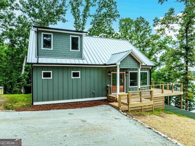 631 Susan Davis Rd, Sparta, GA 31087 - view of front of property with board and batten siding, a deck, a standing seam roof, and a metal roof