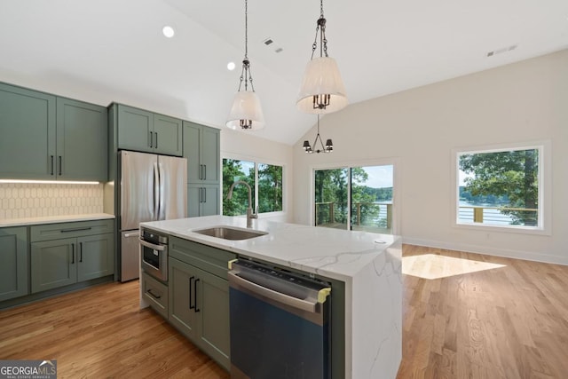 631 Susan Davis Rd, Sparta, GA 31087 - kitchen with stainless steel appliances, green cabinetry, pendant lighting, light wood-style floors, and high vaulted ceiling