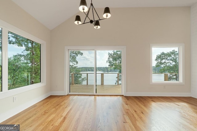 631 Susan Davis Rd, Sparta, GA 31087 - spare room featuring a chandelier, light wood-style floors, and lofted ceiling