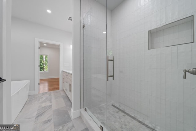 631 Susan Davis Rd, Sparta, GA 31087 - bathroom featuring a shower stall, vanity, a freestanding bath, recessed lighting, and marble finish flooring