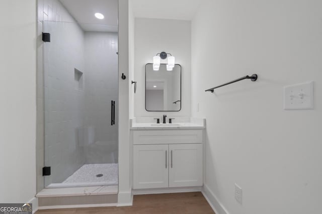 631 Susan Davis Rd, Sparta, GA 31087 - full bathroom with a shower stall, vanity, wood finished floors, and recessed lighting