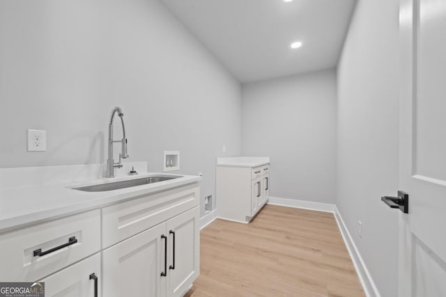 631 Susan Davis Rd, Sparta, GA 31087 - laundry room with cabinet space, washer hookup, light wood-type flooring, and recessed lighting