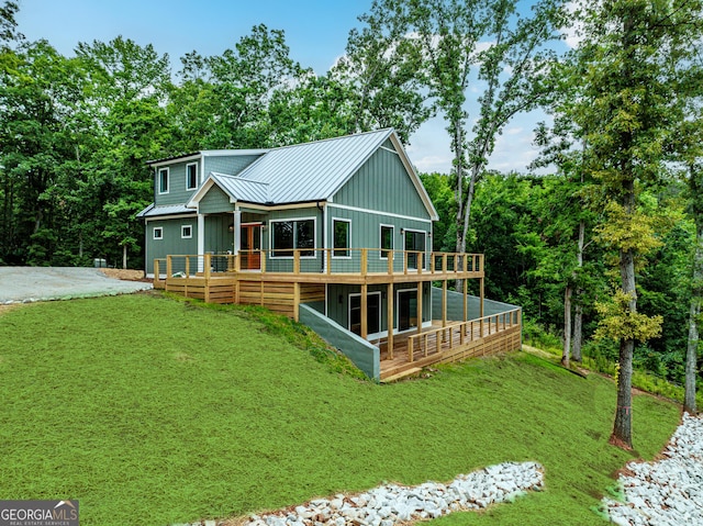 631 Susan Davis Rd, Sparta, GA 31087 - view of front facade featuring a standing seam roof, a metal roof, board and batten siding, a front yard, and a deck