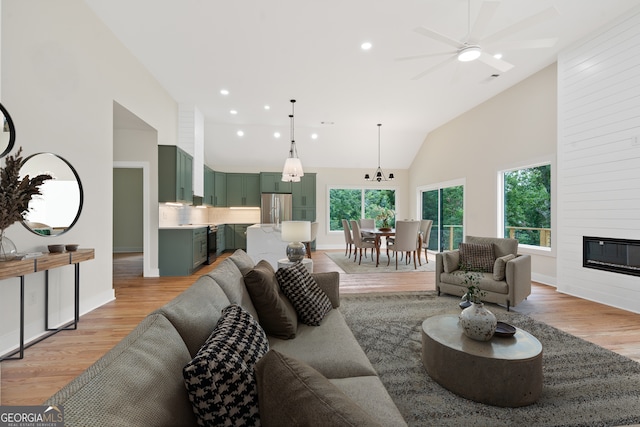 631 Susan Davis Rd, Sparta, GA 31087 - living room with high vaulted ceiling, light wood-type flooring, a ceiling fan, recessed lighting, and a large fireplace